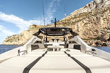 The front of a boat with a mountain in the background