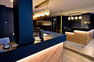 The word hotel is on the wall behind the counter