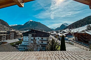 A view of a ski resort with mountains in the background