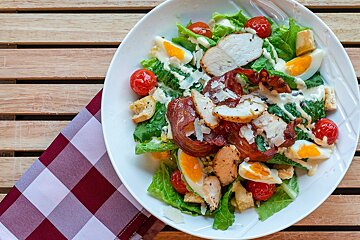 A salad with chicken bacon and hard boiled eggs