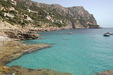 bay with clear water and some boats