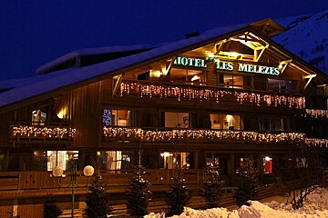 The hotel les melezes is lit up at night