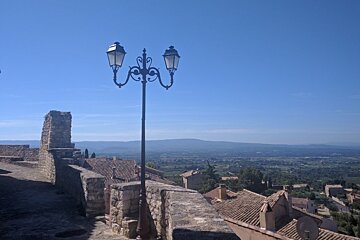 a lamp post and stone walls in provence
