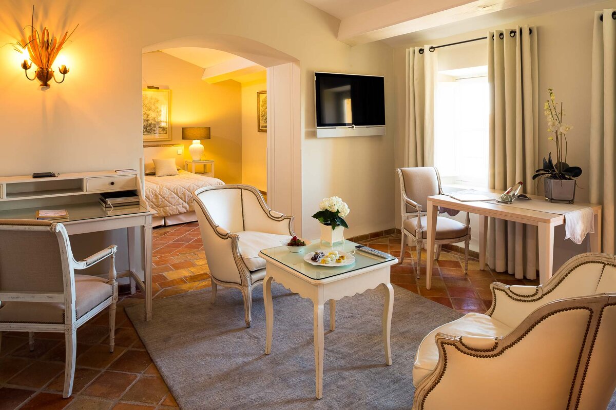 A living room with chairs a table and a flat screen tv