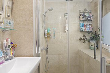 A bathroom with a thermometer and a toothbrush holder