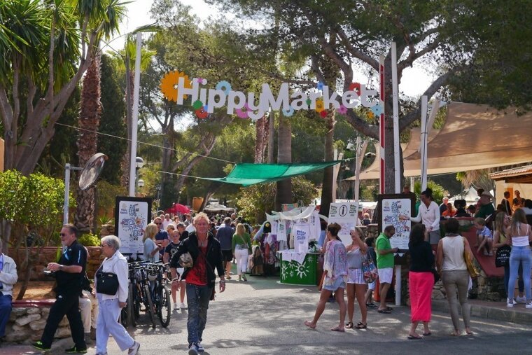 A crowd of people are gathered at the hippy market