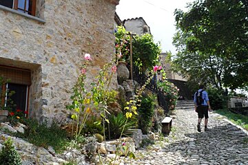 a man walking on a cobbled street