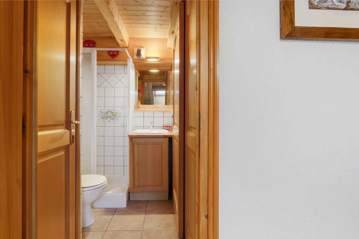 A bathroom with a toilet a sink and a mirror