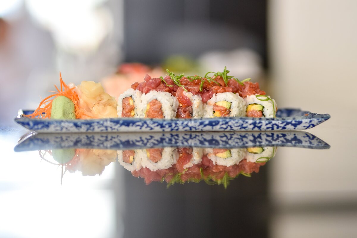 A blue and white plate with sushi on it