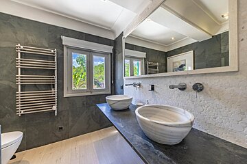 A bathroom with two sinks and a large mirror