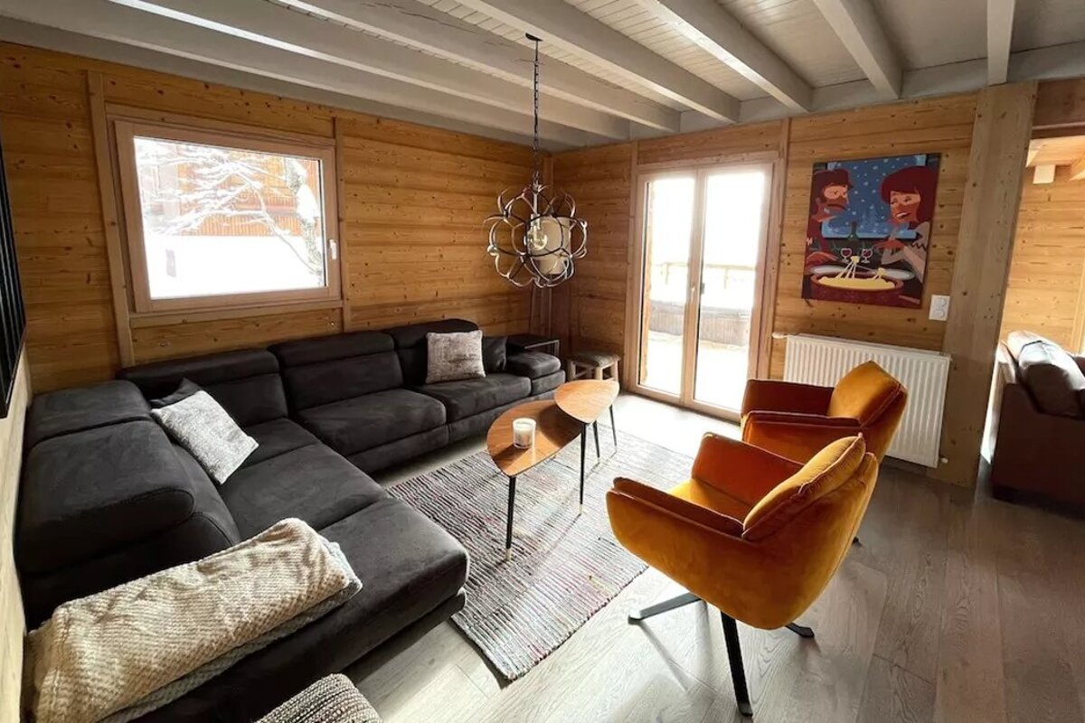 A living room with a couch and two chairs