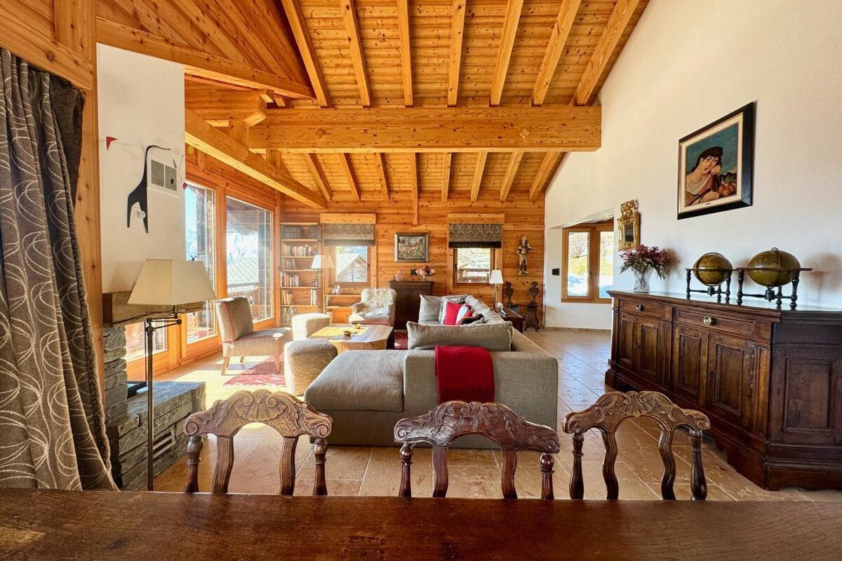 A living room with a couch and chairs in it