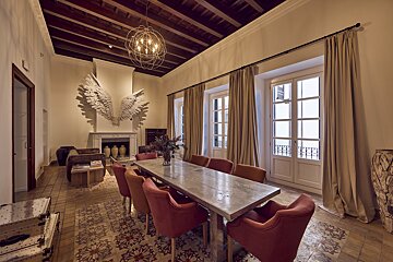 A dining room with a large table and chairs