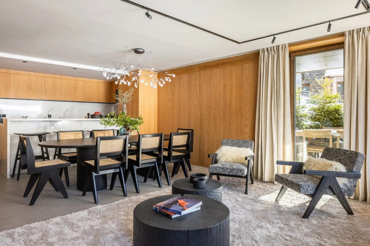 A living room with a dining table and chairs