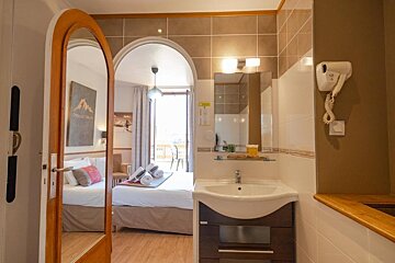 A bathroom in a hotel room with a sign on the wall that says