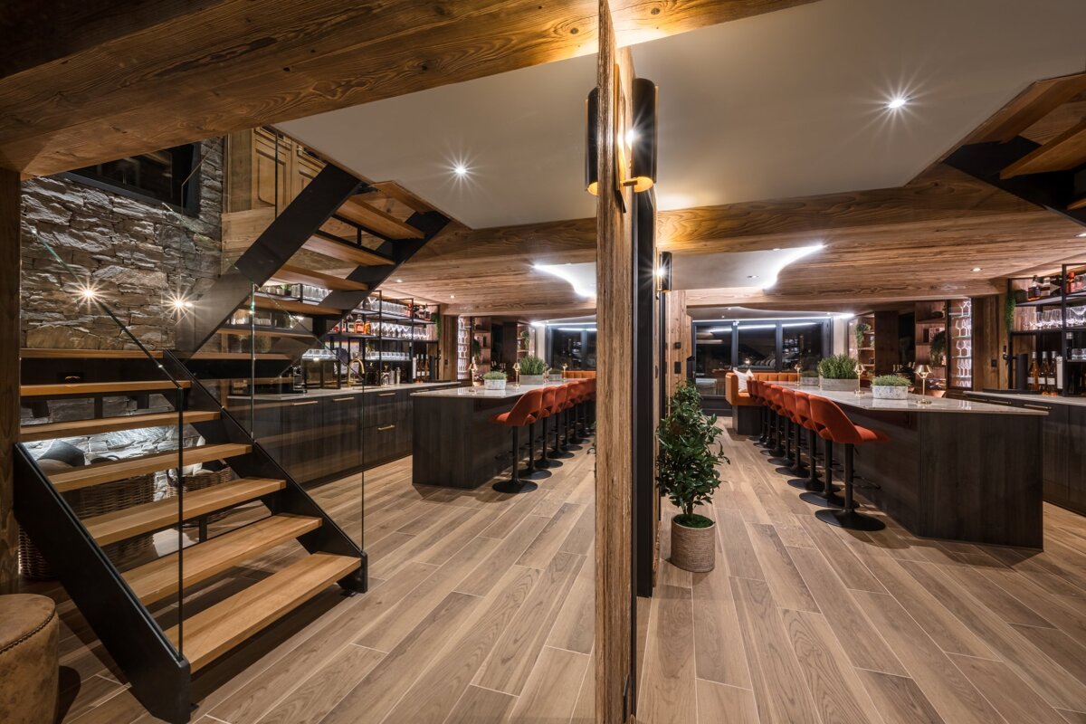 A kitchen with a staircase leading up to the second floor