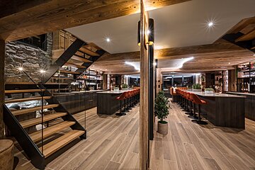 A kitchen with a staircase leading up to the second floor