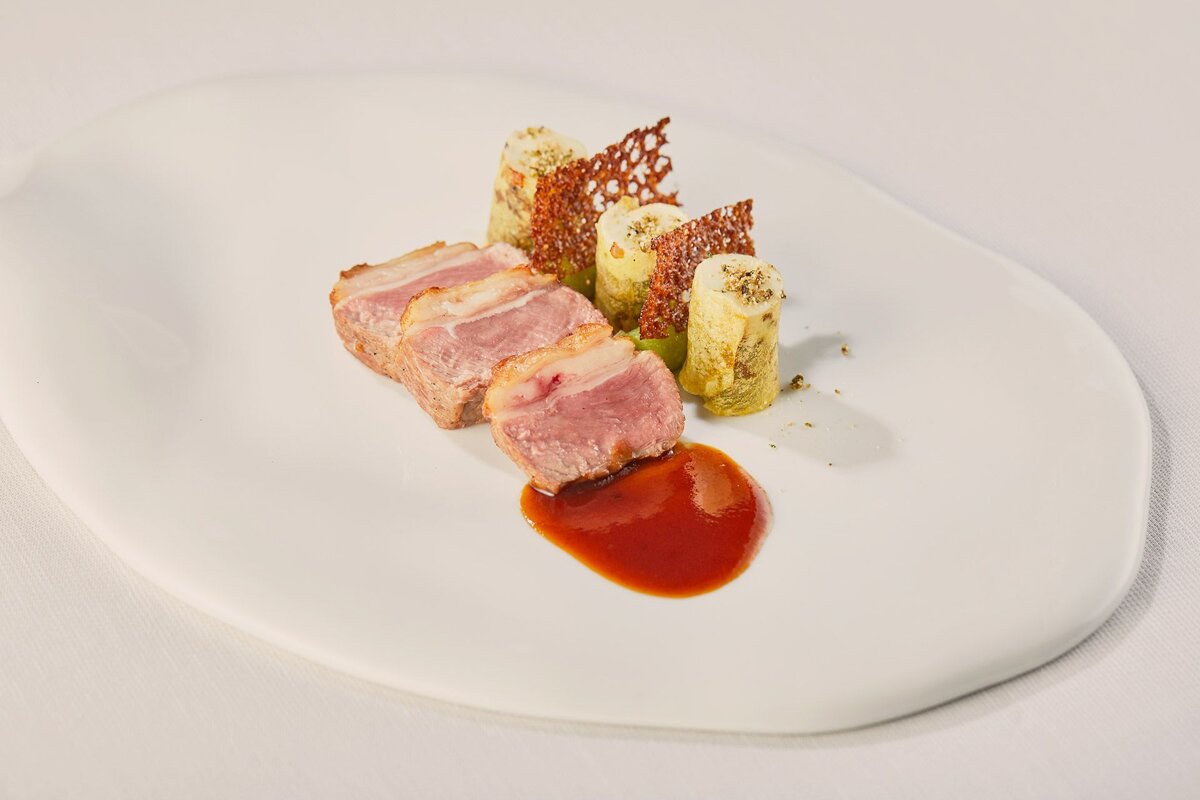 A white plate with meat and vegetables on it