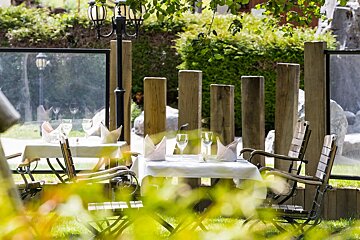 A table with a white table cloth and wine glasses on it