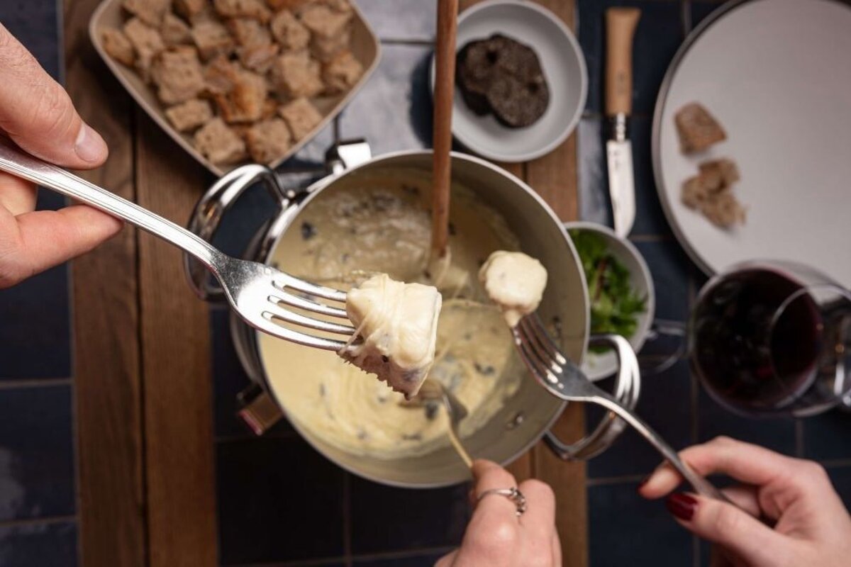 Eating cheese fondue at La Fèrma restaurant in Courchevel