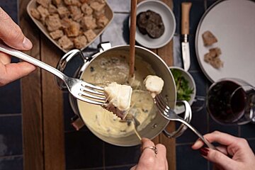 Eating cheese fondue at La Fèrma restaurant in Courchevel