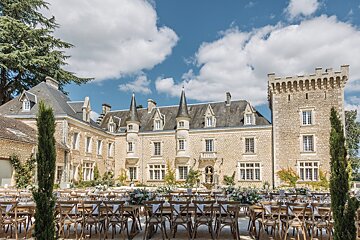 A castle with tables and chairs in front of it