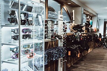 A store filled with lots of different types of goggles and helmets
