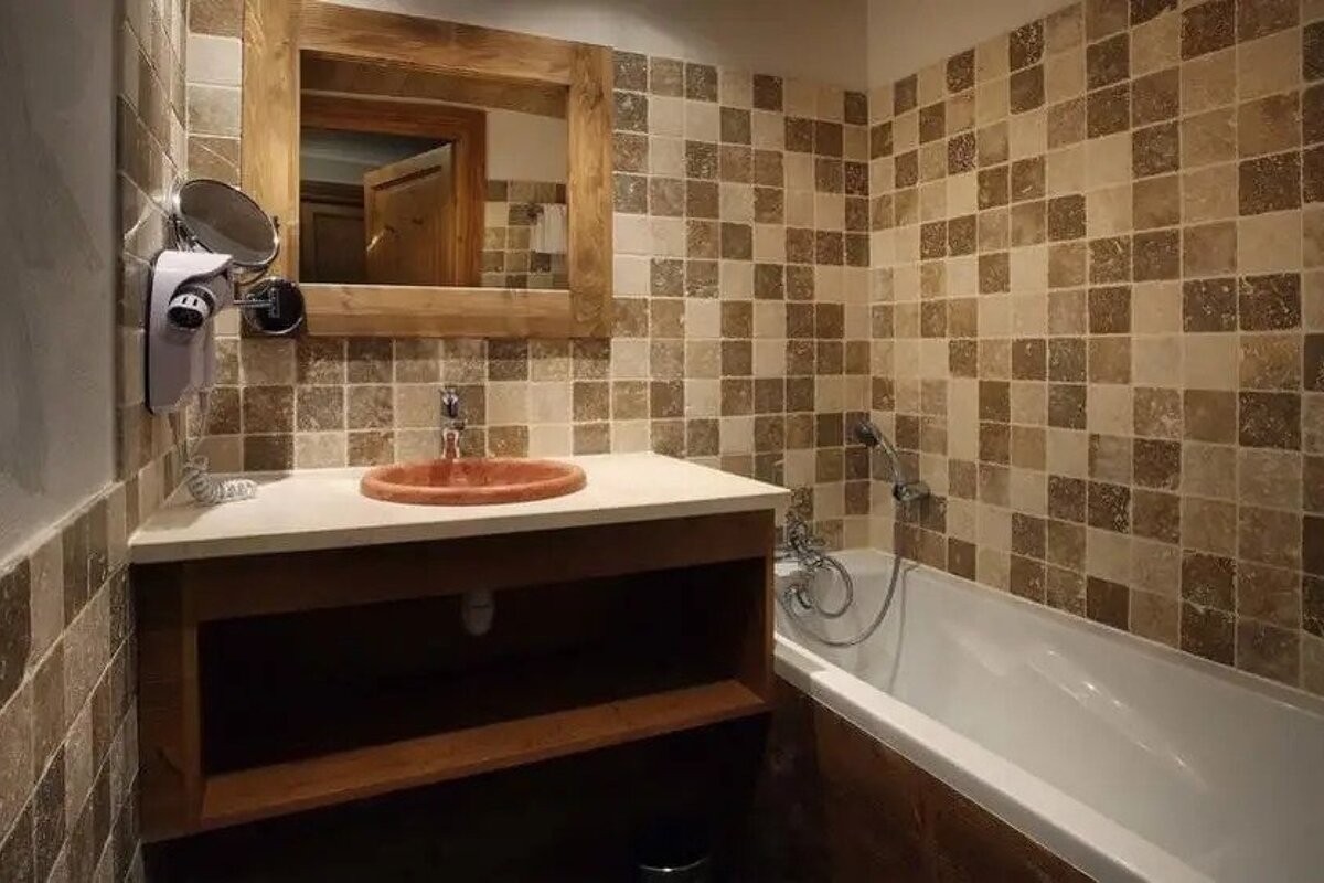 A bathroom with a sink a mirror and a bathtub