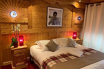 A bedroom with a picture of elvis presley on the wall above the bed