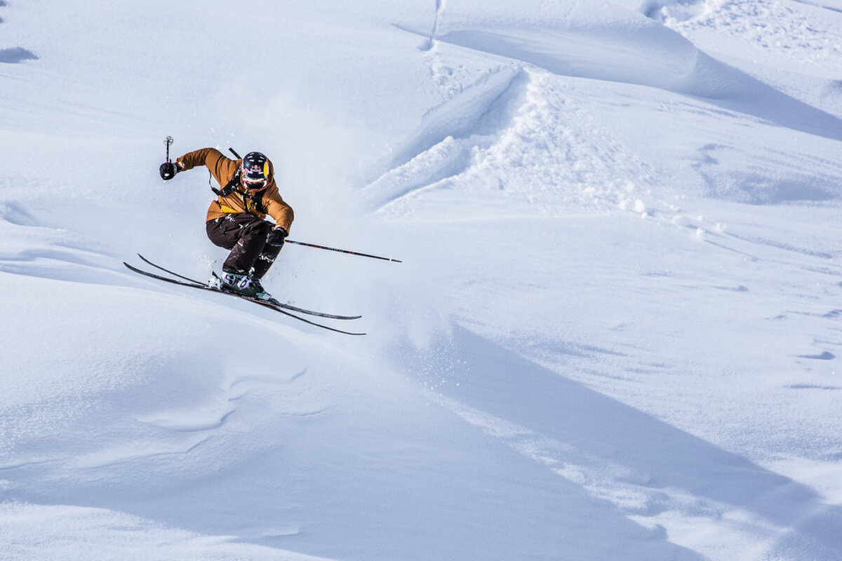 A person is skiing down a snow covered slope