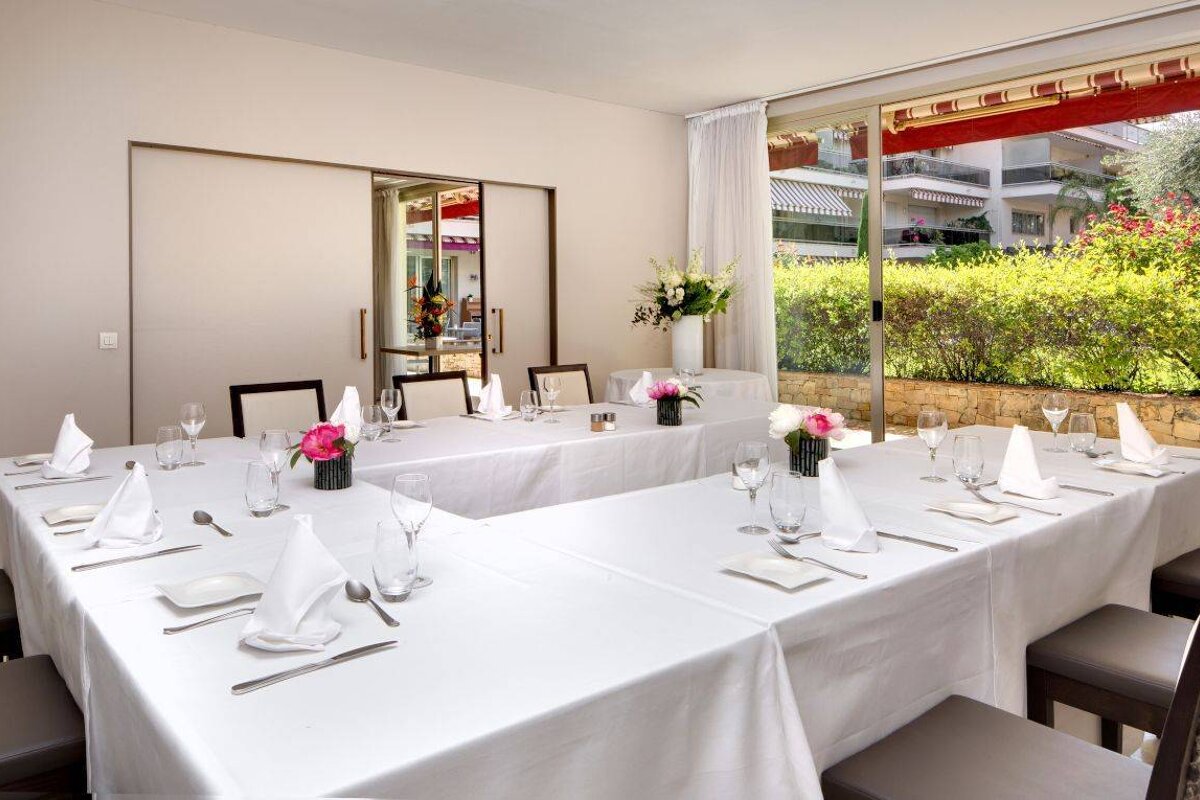 A dining room with a long table and chairs