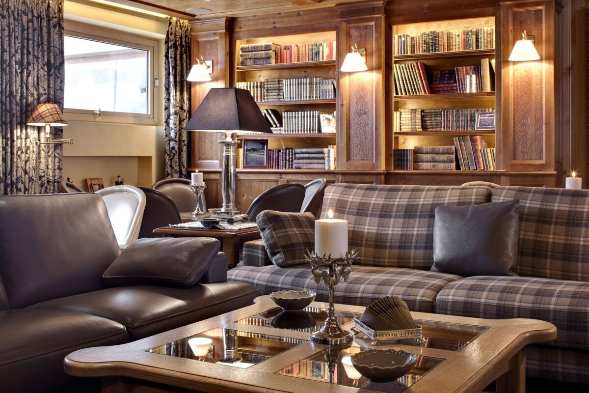 A living room with a plaid couch and a coffee table
