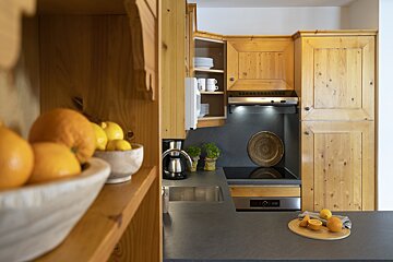 A kitchen with wooden cabinets and stainless steel appliances
