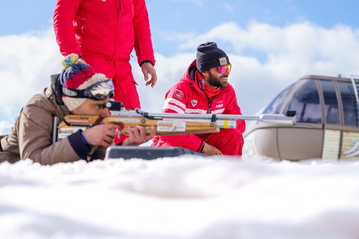 A man in a red jacket with the word rossignol on it