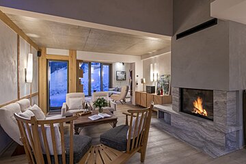 A living room with a fireplace and a book on a table