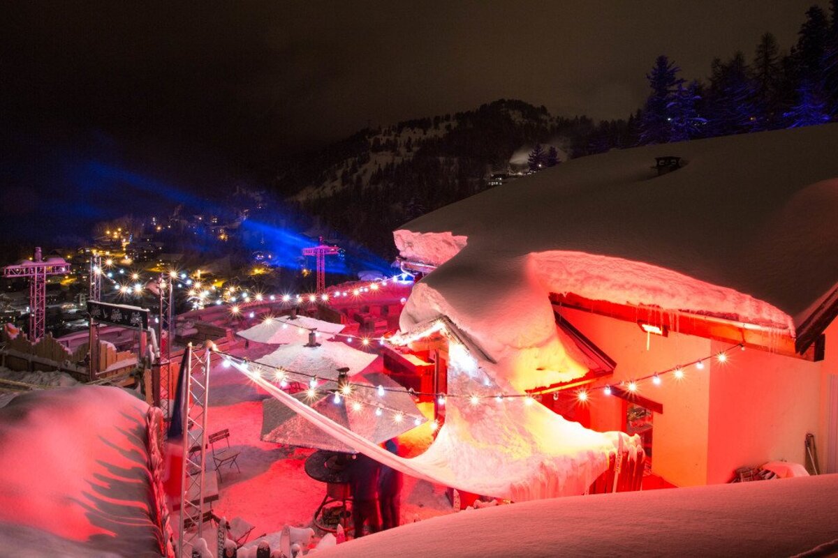 a chalet lit up at night