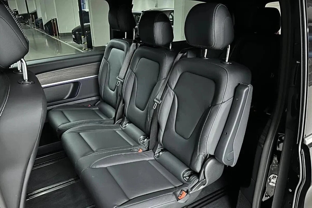 The rear seats of a black van are empty