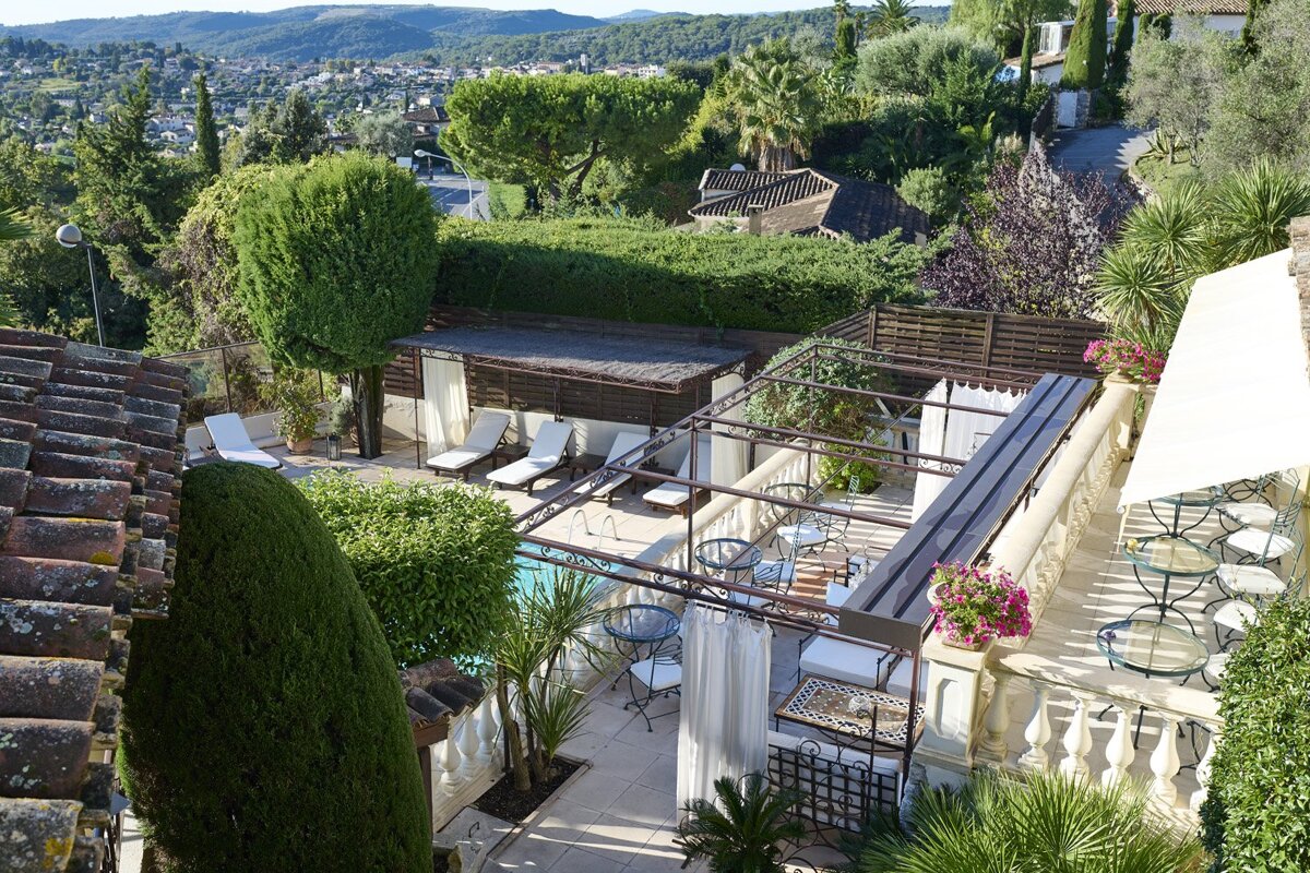 An aerial view of a house with a swimming pool