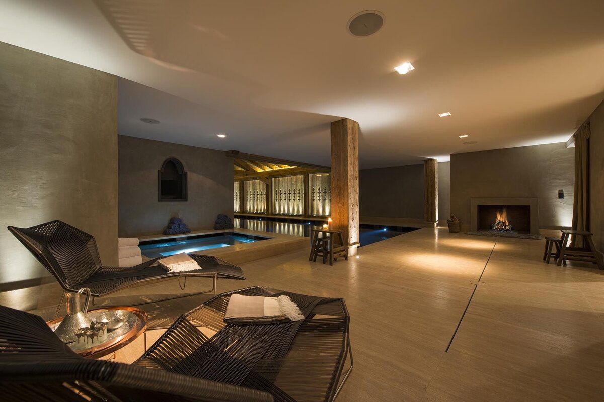 A large room with a fireplace and a swimming pool