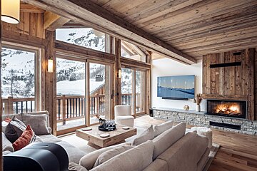 A living room with a fireplace and a painting on the wall