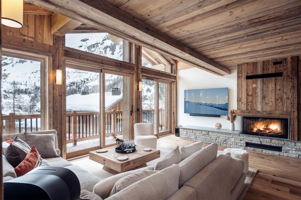 A living room with a fireplace and a painting on the wall