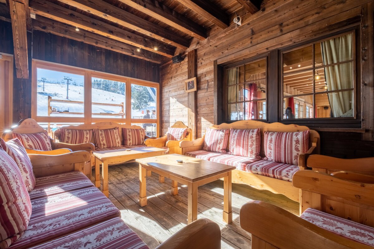 A wooden room with a couch and a table