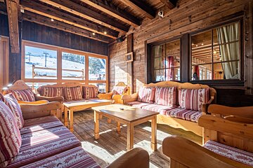 A wooden room with a couch and a table