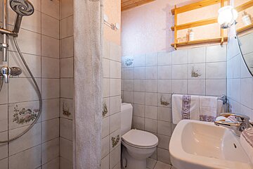 A bathroom with a toilet and a sink and a towel that says ce hotel