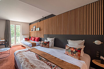 A hotel room with two beds and a table