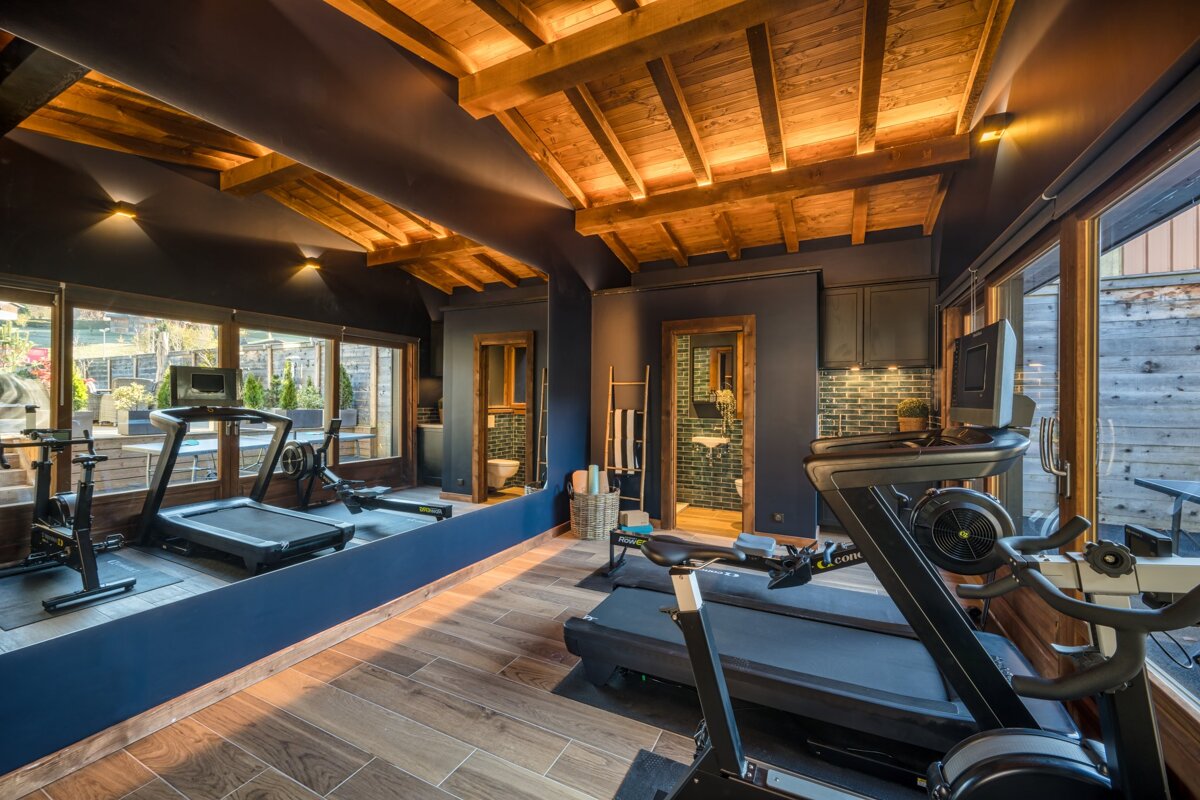 A gym with treadmills and a rowing machine