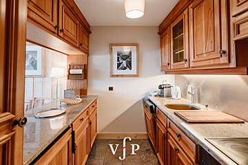 A kitchen with a picture on the wall that says vjp