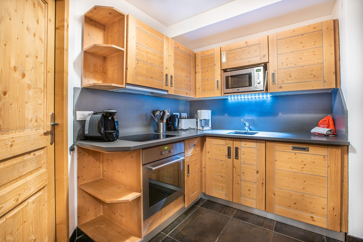 A kitchen with wooden cabinets and stainless steel appliances
