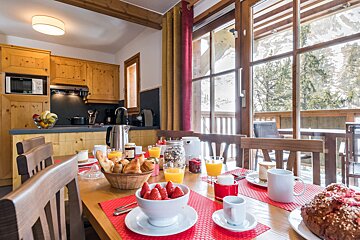 A table with a bowl of strawberries on it