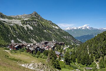 A small village in the mountains with a mountain in the background